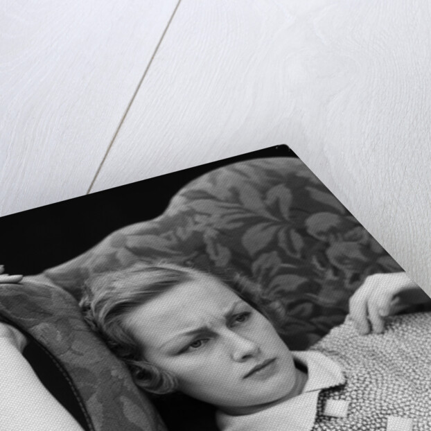 1930s woman sitting slumped position with a worried expression and a furrowed brow by Anonymous