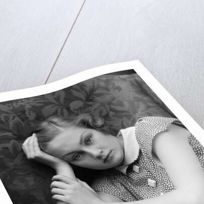 1930s woman moping looking sad or depressed or with a headache leaning her head on her hand looking at camera by Anonymous