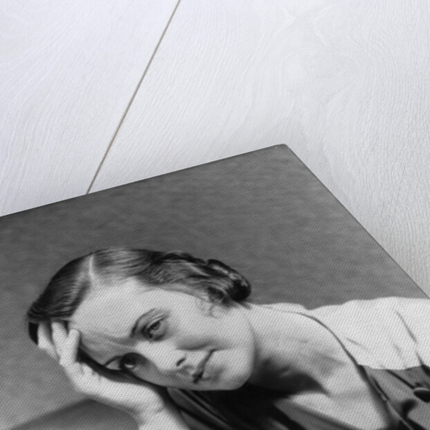 1930s 1940s woman sitting in chair worried sad expression one hand up to her forehead by Anonymous
