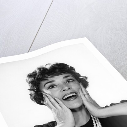 1950s 1960s woman 3 strand necklace hand up to cheeks happy smiling by Anonymous