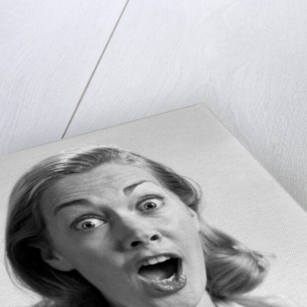 1960s head shot woman eyes and mouth wide open terrified expression looking at camera by Anonymous