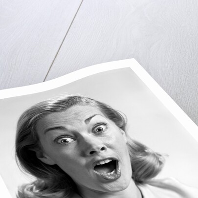 1960s head shot woman eyes and mouth wide open terrified expression looking at camera by Anonymous
