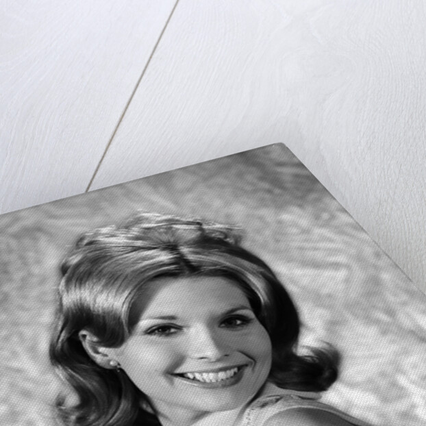 1960s portrait smiling blond woman looking at camera over shoulder by Anonymous