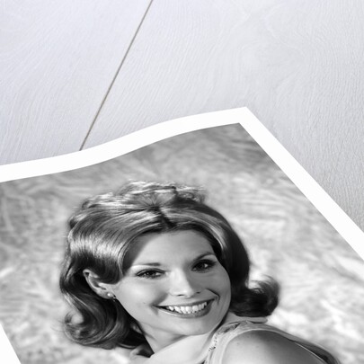 1960s portrait smiling blond woman looking at camera over shoulder by Anonymous