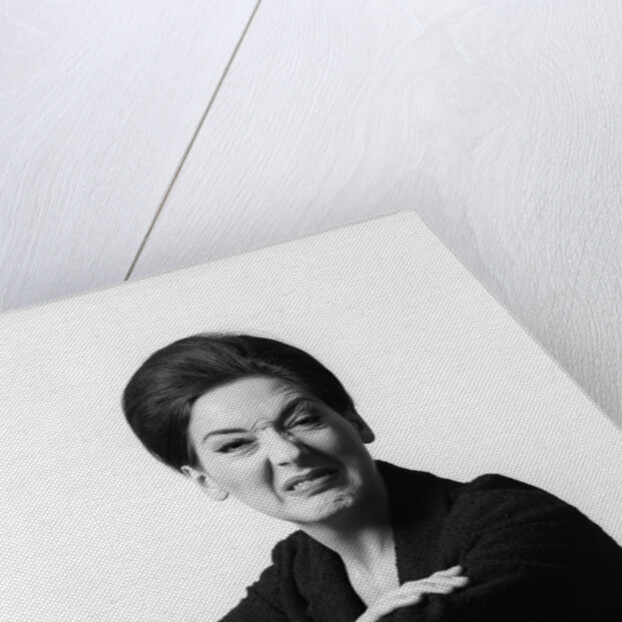 1960s 1970s brunette middle aged woman making funny face looking at camera with wrinkled nose and arms folded on back of chair by Anonymous