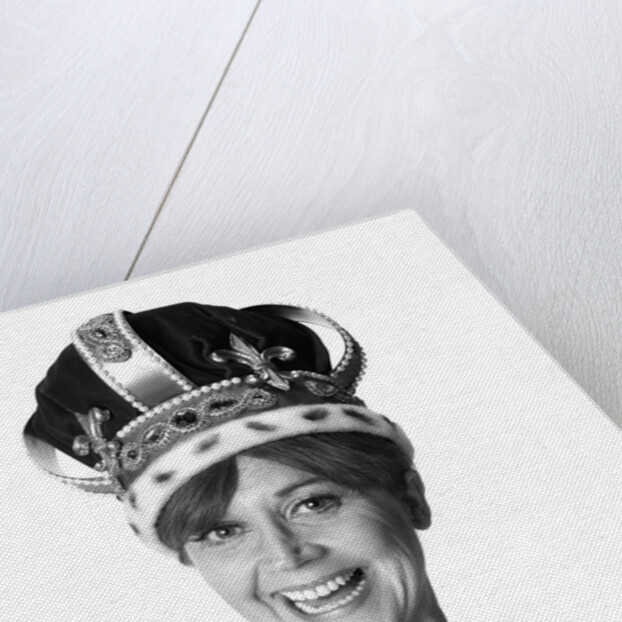 1970s smiling portrait woman wearing queen's crown looking at camera by Anonymous