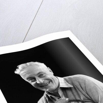 1920s smiling man marking golf club scorecard looking at camera by Anonymous