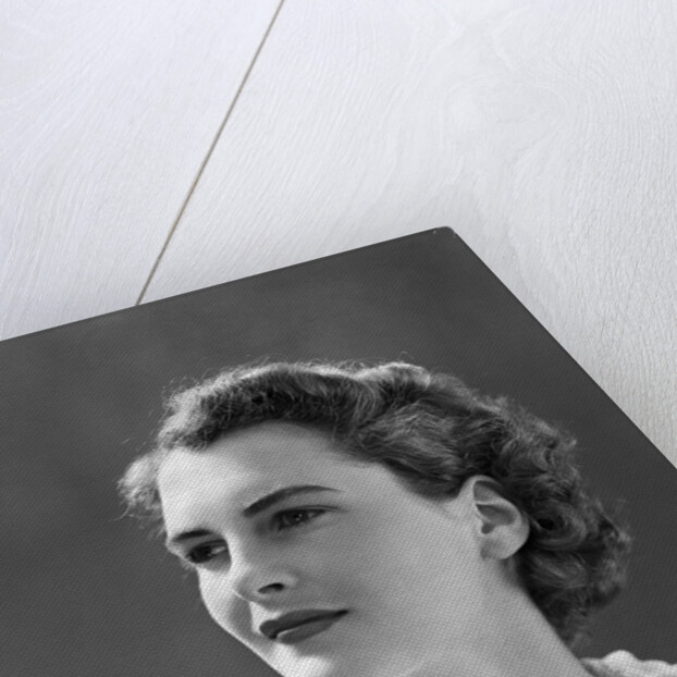 1940s profile portrait brunette woman wearing print dress with lace collar by Anonymous