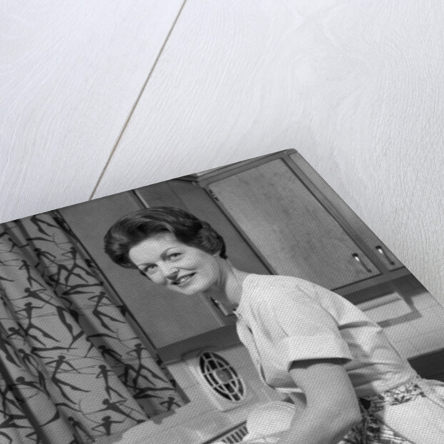 1960s woman housewife washing dishes in kitchen sink looking at camera by Anonymous
