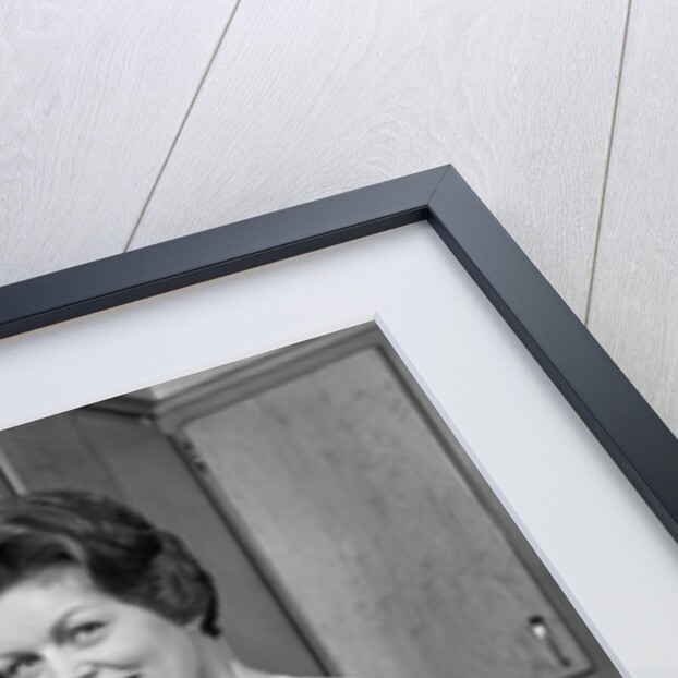 1960s woman housewife washing dishes in kitchen sink looking at camera by Anonymous