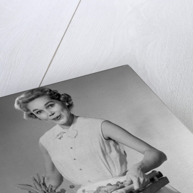 1950s woman looking at camera smiling holding platter of hors d'oeuvres snacks by Anonymous
