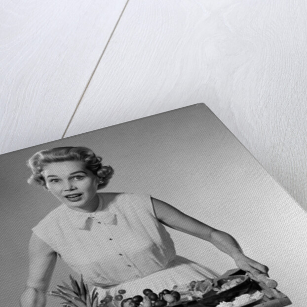 1950s woman looking at camera speaking holding platter of hors d'oeuvres snacks by Anonymous