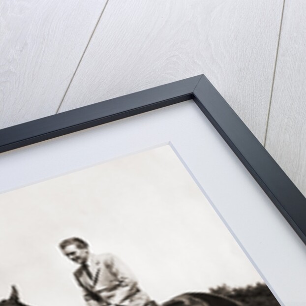 1930s 1940s couple in riding gear man riding horse woman standing by wooden fence by Anonymous