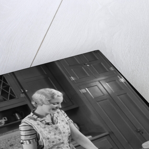 1930s woman in kitchen making strawberry shortcake by Anonymous