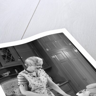 1930s woman in kitchen making strawberry shortcake by Anonymous