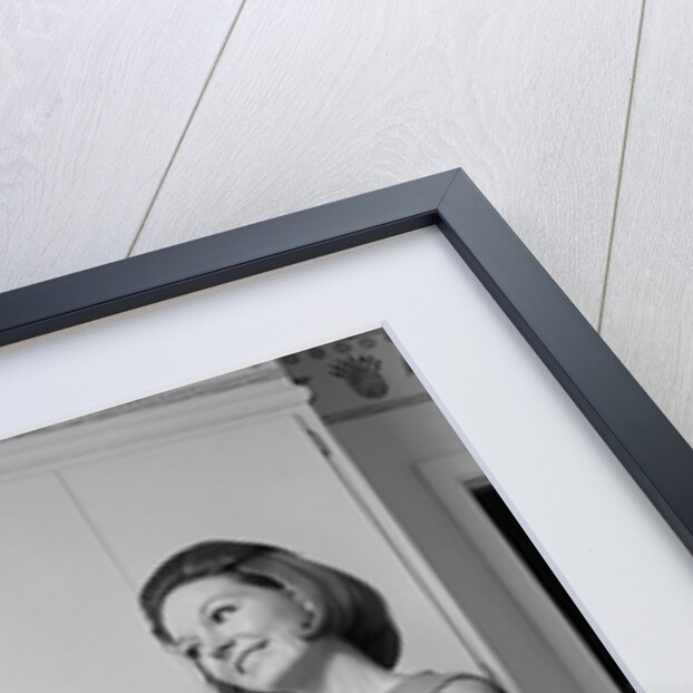 1960s satisfied woman homemaker holding folded laundry by Anonymous