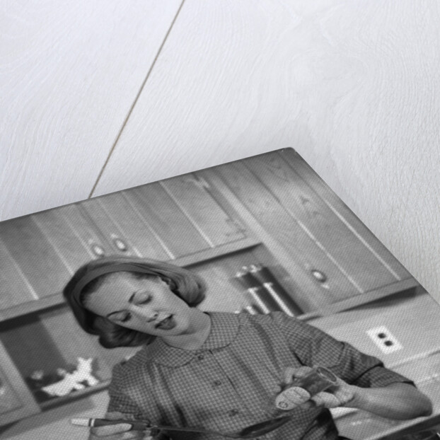 1960s woman baking in kitchen by Anonymous