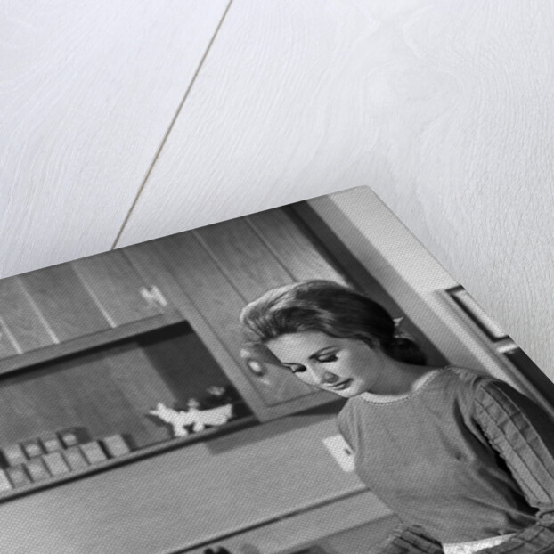 1960s woman housewife baking biscuits in kitchen by Anonymous