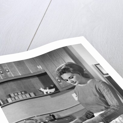 1960s woman housewife baking biscuits in kitchen by Anonymous