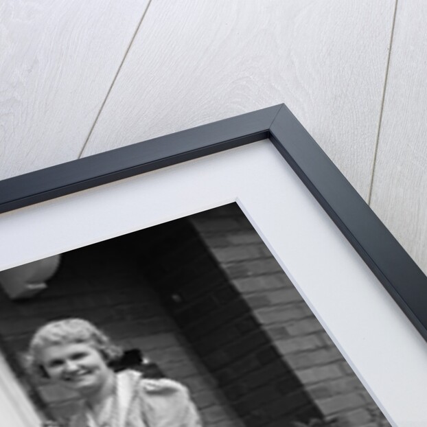 1940s smiling woman sweeping porch front door step with a broom looking at camera by Anonymous