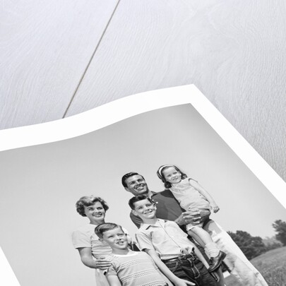 1960s smiling family portrait standing on grass mother father three children by Anonymous