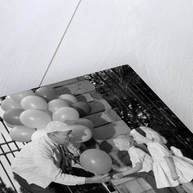 1960s children boy girl getting a balloon from man by Anonymous