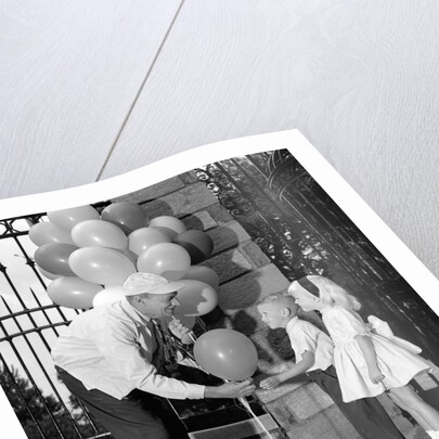 1960s children boy girl getting a balloon from man by Anonymous