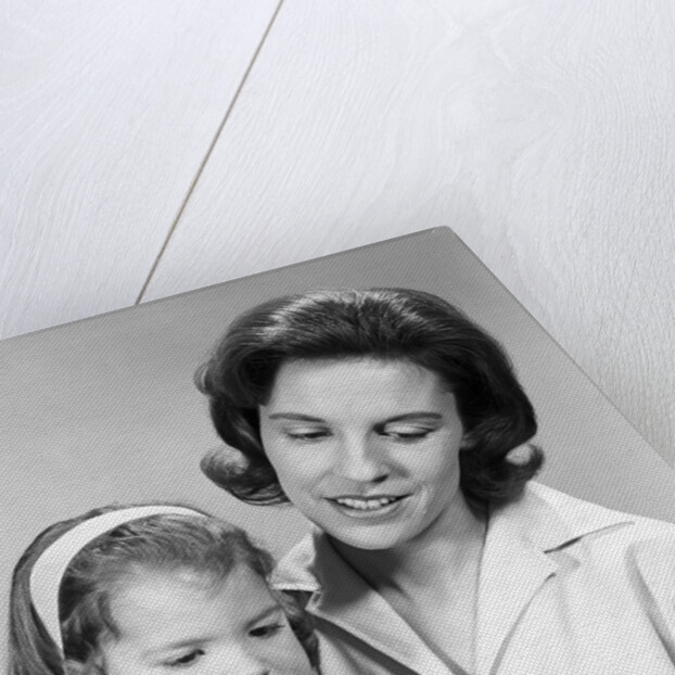 1960s woman reading story book to girl child by Anonymous