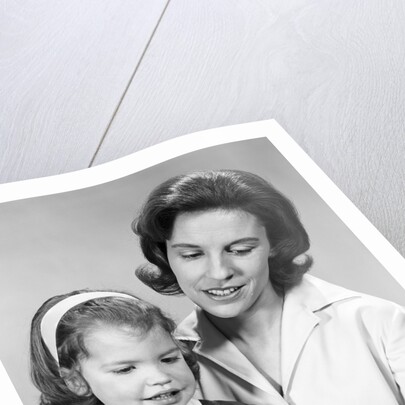 1960s woman reading story book to girl child by Anonymous