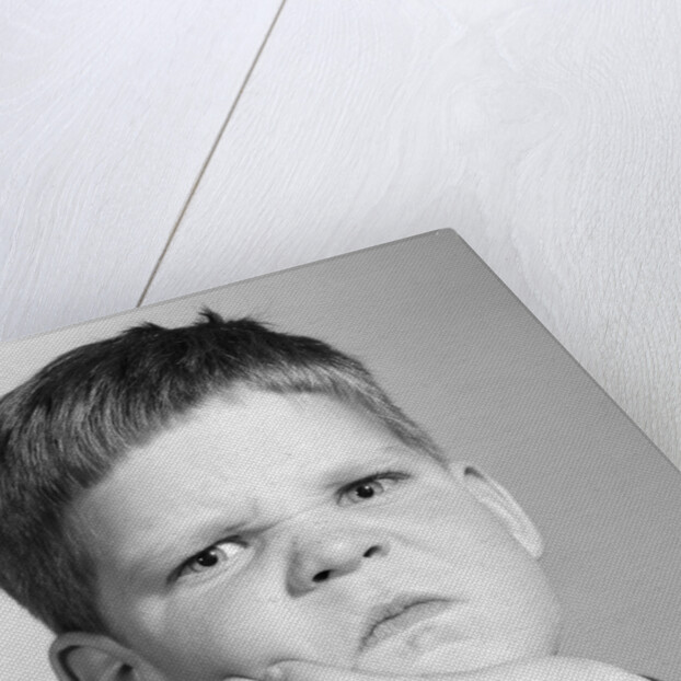 1960s little boy making angry funny facial expression looking at camera by Anonymous