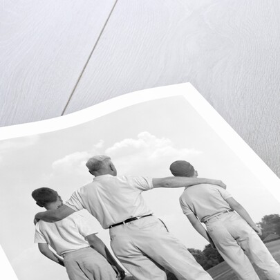 1960s back view grandfather with two grandsons boys by Anonymous