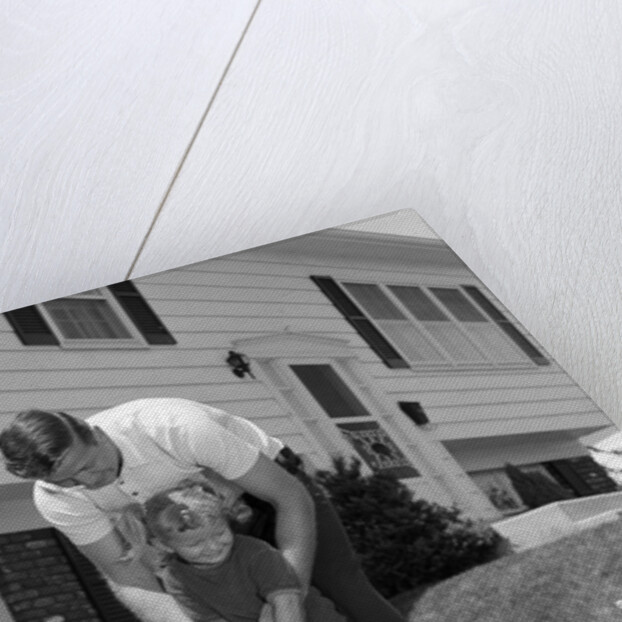 1960s father and young daughter playing croquet in yard by Anonymous