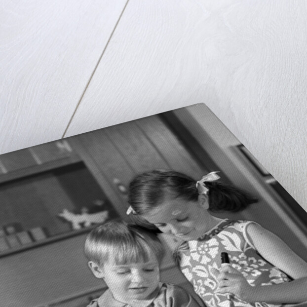 1960s two children boy girl bowl mixing pouring milk in kitchen by Anonymous