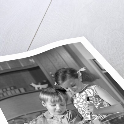 1960s two children boy girl bowl mixing pouring milk in kitchen by Anonymous