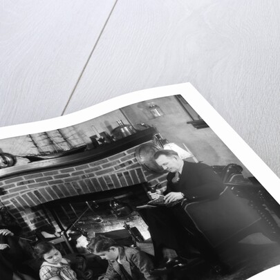 1930s family of four sitting in front fireplace mother knitting father reading smoking pipe kids doing homework by Anonymous