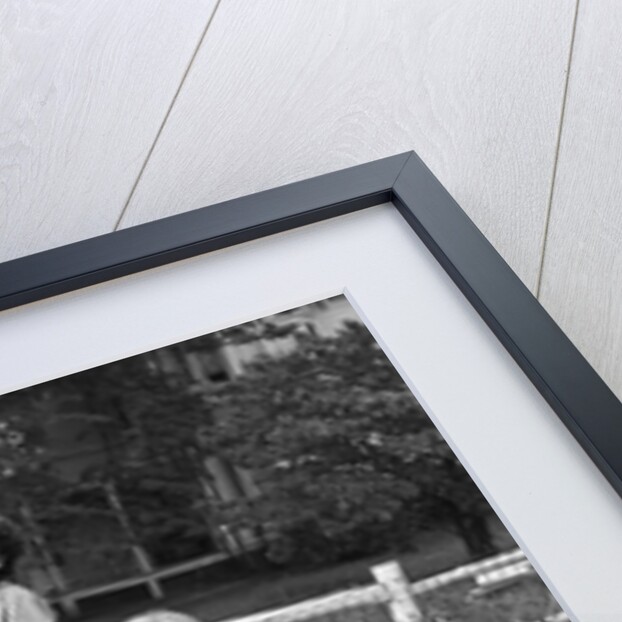 1950s mom & kids serving dad in hammock by Anonymous