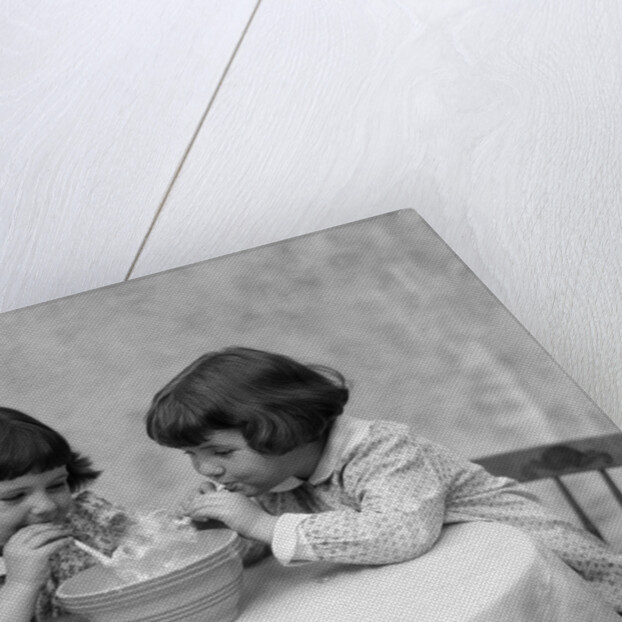 1930s two girls playing blowing soap bubble pipes by Anonymous
