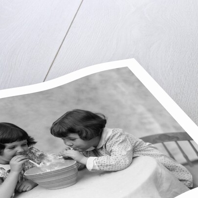 1930s two girls playing blowing soap bubble pipes by Anonymous