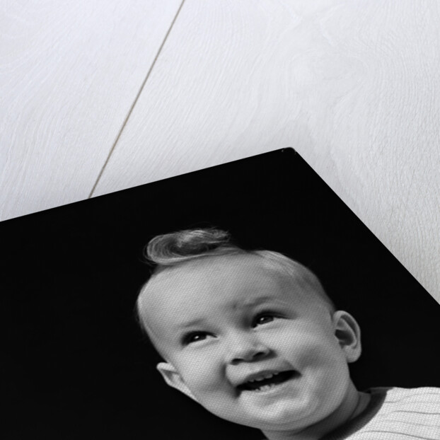 1940s smiling blond boy with big curl on top of head looking up by Anonymous