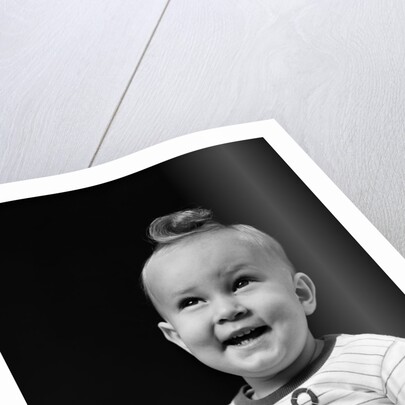 1940s smiling blond boy with big curl on top of head looking up by Anonymous