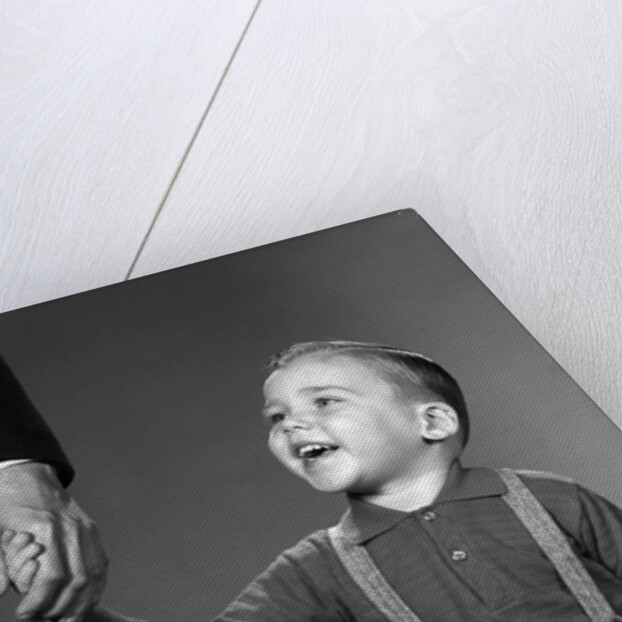1960s boy holding adult male hand smiling by Anonymous