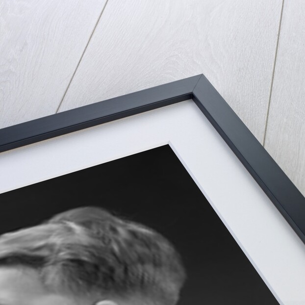 1940s boy blowing up balloon by Anonymous