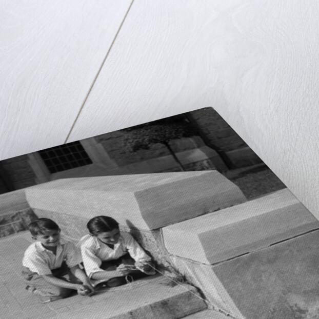 1930s two boys playing trick with string tied to lost purse by Anonymous