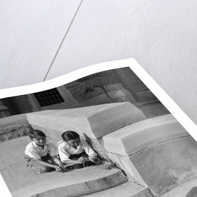 1930s two boys playing trick with string tied to lost purse by Anonymous