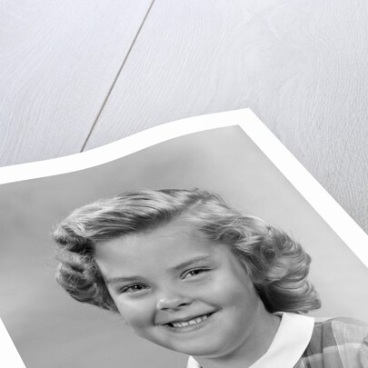 1950s portrait smiling girl with white collar plaid dress looking at camera by Anonymous
