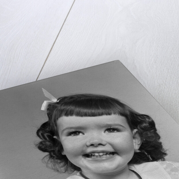 1950s smiling brunette girl with bangs by Anonymous