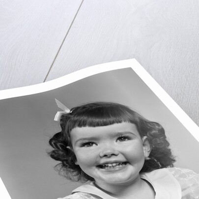 1950s smiling brunette girl with bangs by Anonymous
