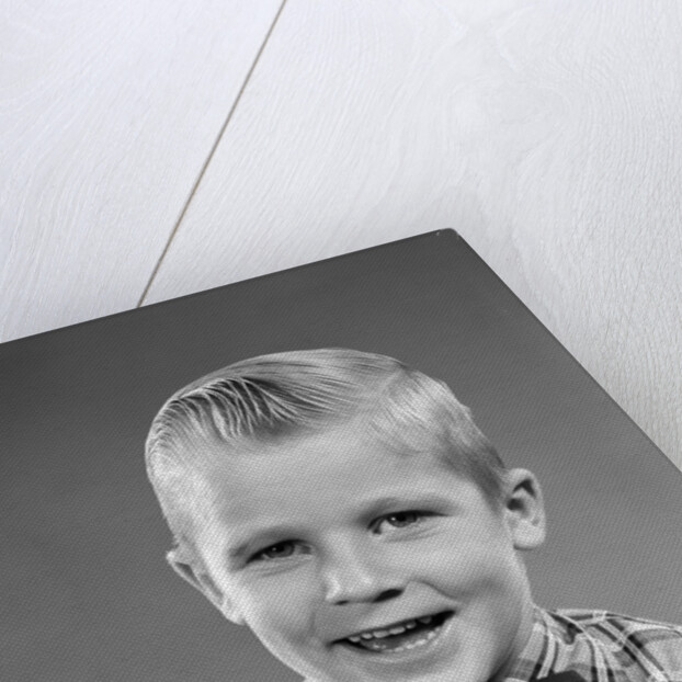 1950s smiling blond boy wearing plaid shirt bow ties looking at camera by Anonymous