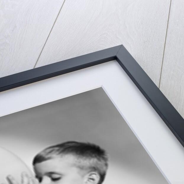 1950s little boy blowing up big balloon little girl with fingers in ears eyes closed by Anonymous