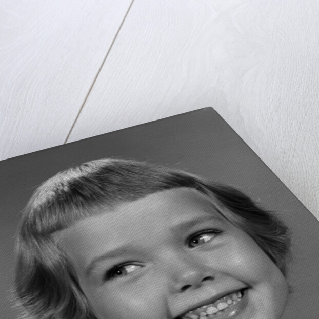 1960s smiling girl looking off to the side by Anonymous